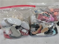 Two bags of doll shoes different sizes