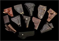 Various leather holster and gun cleaning kit