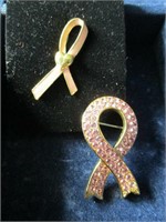 2 pink ribbon pins