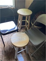 Two metal folding chairs and two barstools