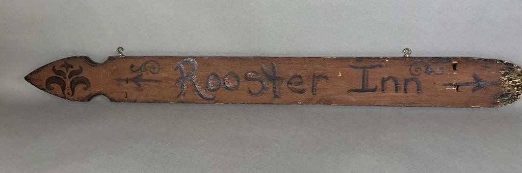 Rooster Inn sign crafted from salvaged fence