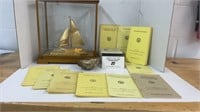 Gold tone sailboat statue in case with Mariner