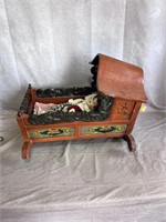 wooden doll bed with dolls