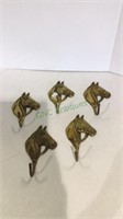 Five brass horse head hooks each measuring 6