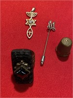 Pendant, M stick pin, thimble and a ring.