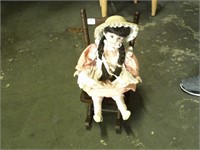 small porcelian doll with doll chair
