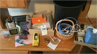 Assortment of pens, paper clips, tape, cords,