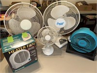 4 table top fans and 1 table top heater fan