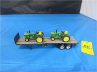 2 John Deere Tractors on flatbed