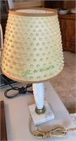 A vintage milk glass hobnail lamp with a marble