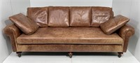 Brown leather sofa, rolled arms, turned legs, long