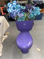 Purple toilet with floral used for toilet paper