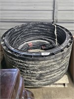 skid of plastic rings & hosing & cast iron caps