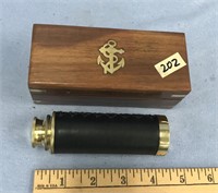 Wooden box with brass accents, 5" long containing
