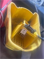 Yellow Commercial mop bucket on wheels