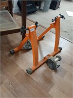 Orange bike inside riding stand