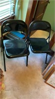 Two black Samsonite folding chairs