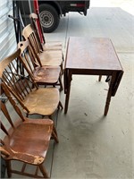 Five solid wood chairs, and a drop leaf table