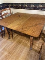 Wood kitchen table and six chairs. Table is on