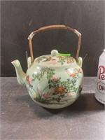 Antique oriental teapot with woven handle