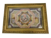 Sailor's Valentine in a rectangular gilt frame.