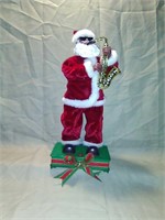 Saxophone Santa dances and sings. 14" tall
