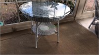 Vintage round wicker table with a shelf below and