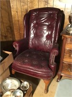 Maroon  wing back chair has damage button back