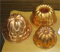 Three copper food molds