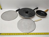 assorted frying pans and spatter guards