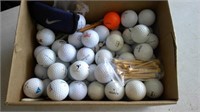 mixture of golf balls, tees