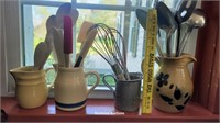 4 pitchers full of utensils