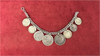 Sterling silver charm bracelet w/ coin charms