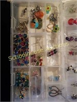 Plastic case full of earring and necklaces
