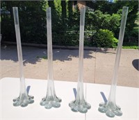 Glass long stem vases. Each 28in tall.