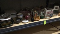 Shelf Full of Snow Globes and Glassware