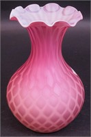 A quilted pink satin glass vase with fluted top,
