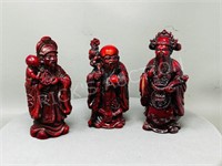 3 red resin Chinese deities