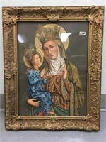 A beautiful, ornately framed religious art work; a