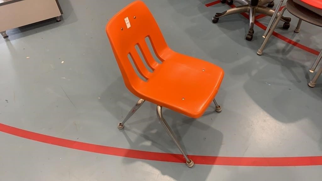 Orange plastic school chair, 30 x 22 inches