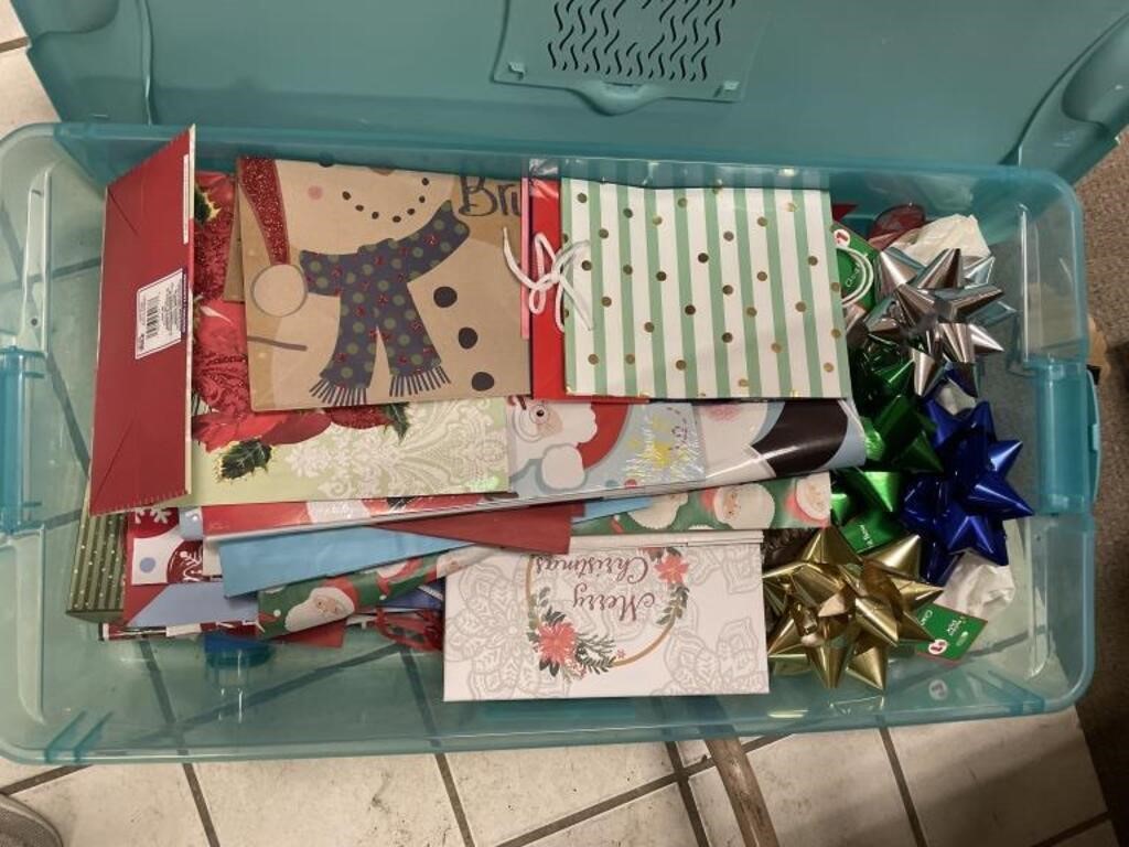 Tote of Christmas gift paper and bows