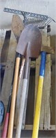 Group of Yard Tools Ax Two Shovels and Racks