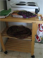 Rolling, oak tea cart with linens