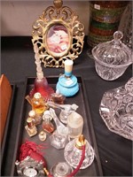 Container of perfume bottles; plus a brass