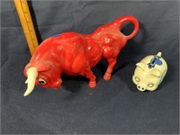 Plastic red bull & stone pig bank