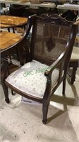 Good size antique arm chair with cane back,