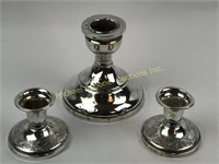 THREE WEIGHTED STERLING CANDLESTICKS