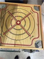 Vintage Carrom board with accessory pieces.
