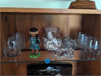 Set of crystal glasses, doll, and candlestick