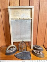 Antique glass washboard and sad irons